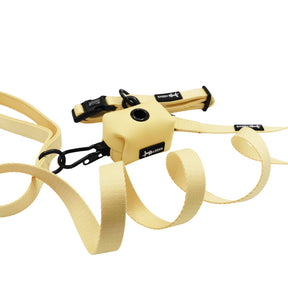The Sassy Woof Dog Three Piece Bundle - Daffodil includes a cream dog leash, matching collar, and small waste bag dispenser with black button and clip, shown on a white background.