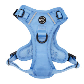 The Sassy Woof Dog Step-in Harness - Hydrangea is light blue with padded, adjustable, reflective straps, black buckles, a metal D-ring, an Air Tag pocket, and a center Sassy Woof logo for comfort and security on walks.