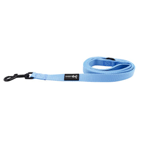 The Sassy Woof Dog Leash - Hydrangea features a light blue hydrangea design, black metal clip, and a black label with “SASSY WOOF” in white. The leash is neatly coiled on a white background.