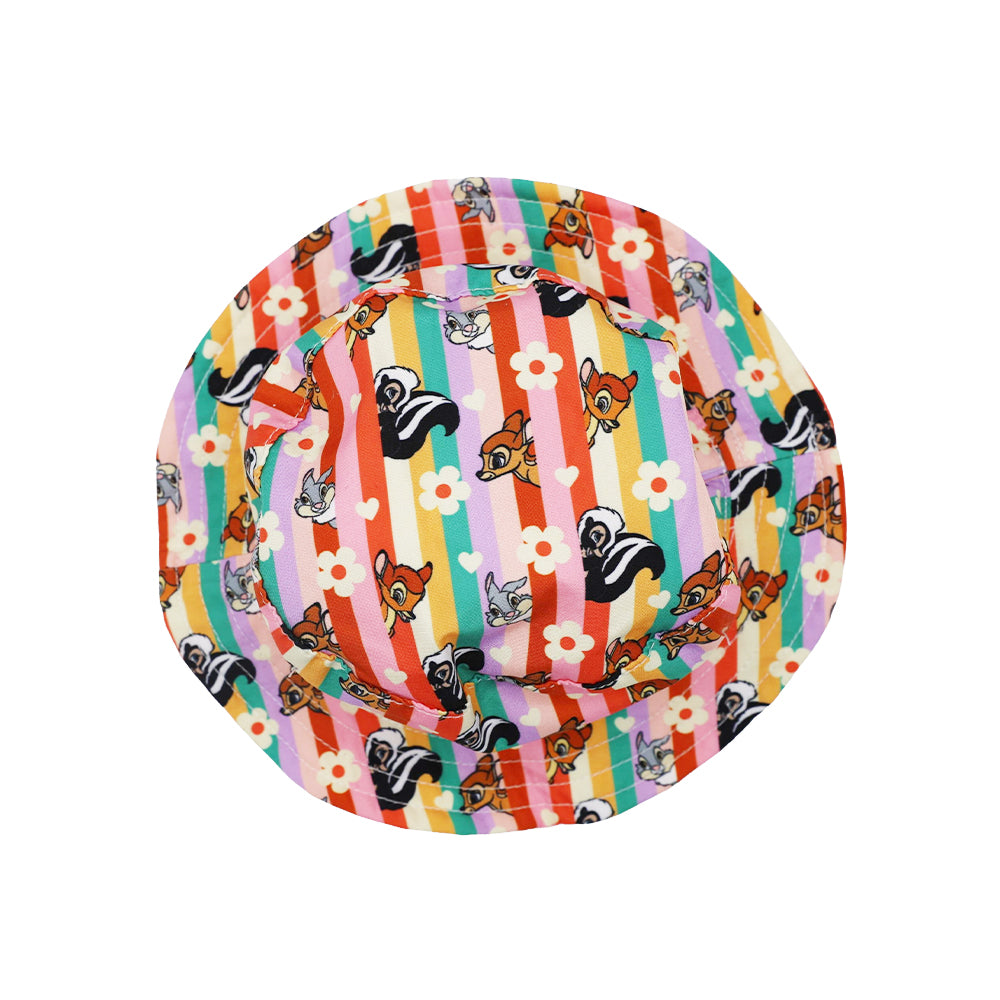 The Sassy Woof Dog Bucket Hat – Disney's Bambi features colorful stripes, white flowers, and cartoon animal faces on a white background—a playful pick for patterned dog hat fans.