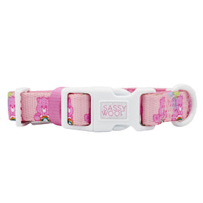 The Sassy Woof Dog Collar - Care Bears™ Cheer Bear is a pink, adjustable dog collar with a white buckle and cute Care Bears and rainbow designs—perfect to pair with the matching harness for extra cuteness on walks.