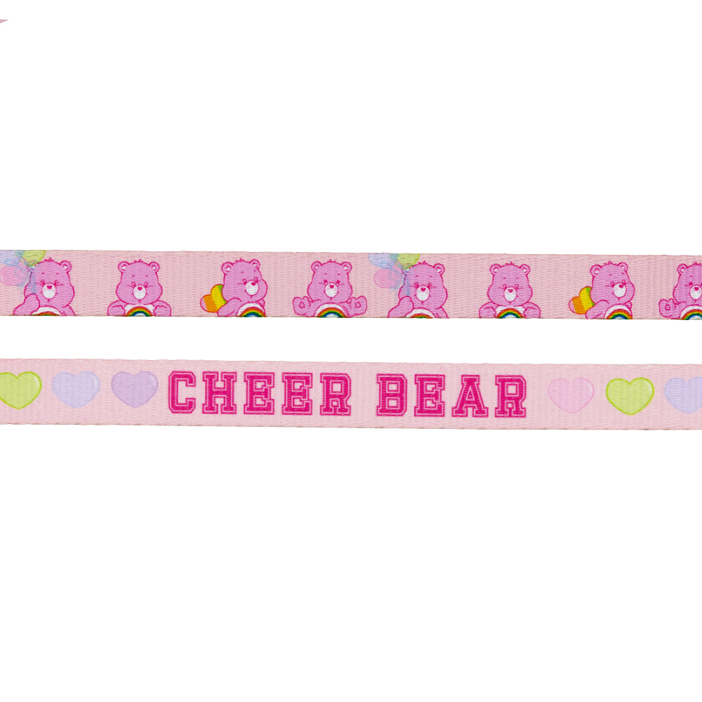 Sassy Woof’s Dog Leash - Care Bears™ Cheer Bear features pink ribbon with repeating Cheer Bear, rainbows, hearts, and balloons. CHEER BEAR is in bold pink letters with pastel hearts—perfect for a cute Care Bears dog harness look.