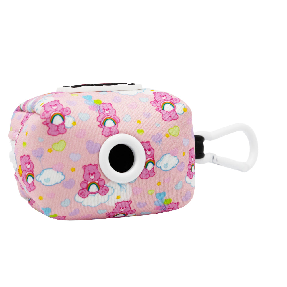 The Sassy Woof Collar Three Piece Bundle - Care Bears™ Cheer Bear is a pink rectangular case with a white clip, featuring pink Care Bears, clouds, colorful hearts, and a round black-and-white dispenser opening. Perfect to pair with the matching dog harness.