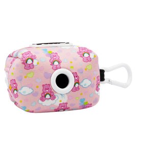 The Sassy Woof Dog Waste Bag Holder - Care Bears™ Cheer Bear features pink cartoon bears, clouds, and hearts, a white plastic clip, and a round black-and-white side opening.