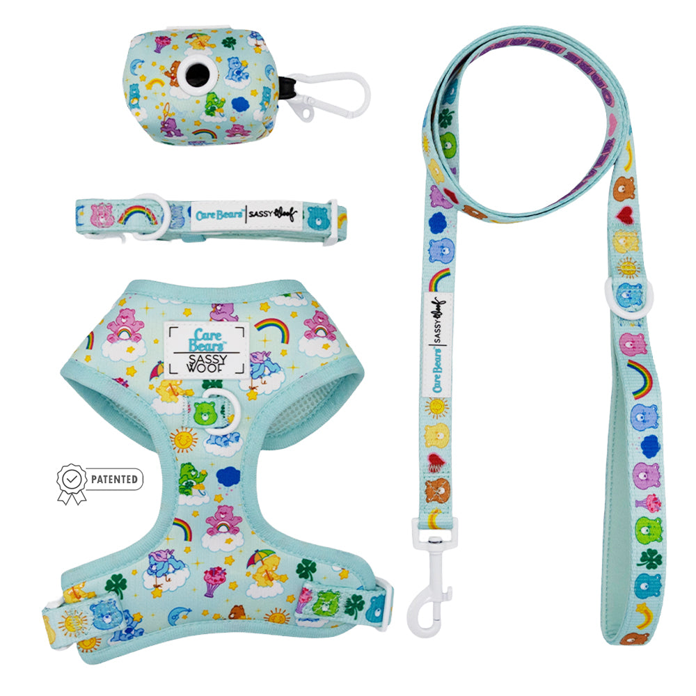 The Sassy Woof Dog Four Piece Bundle - Care Bears™ Care-a Lot features an adjustable harness, collar, leash, and waste bag holder with colorful Care Bears designs—perfect for pups on the Puppy Growth Pawtection Plan!.