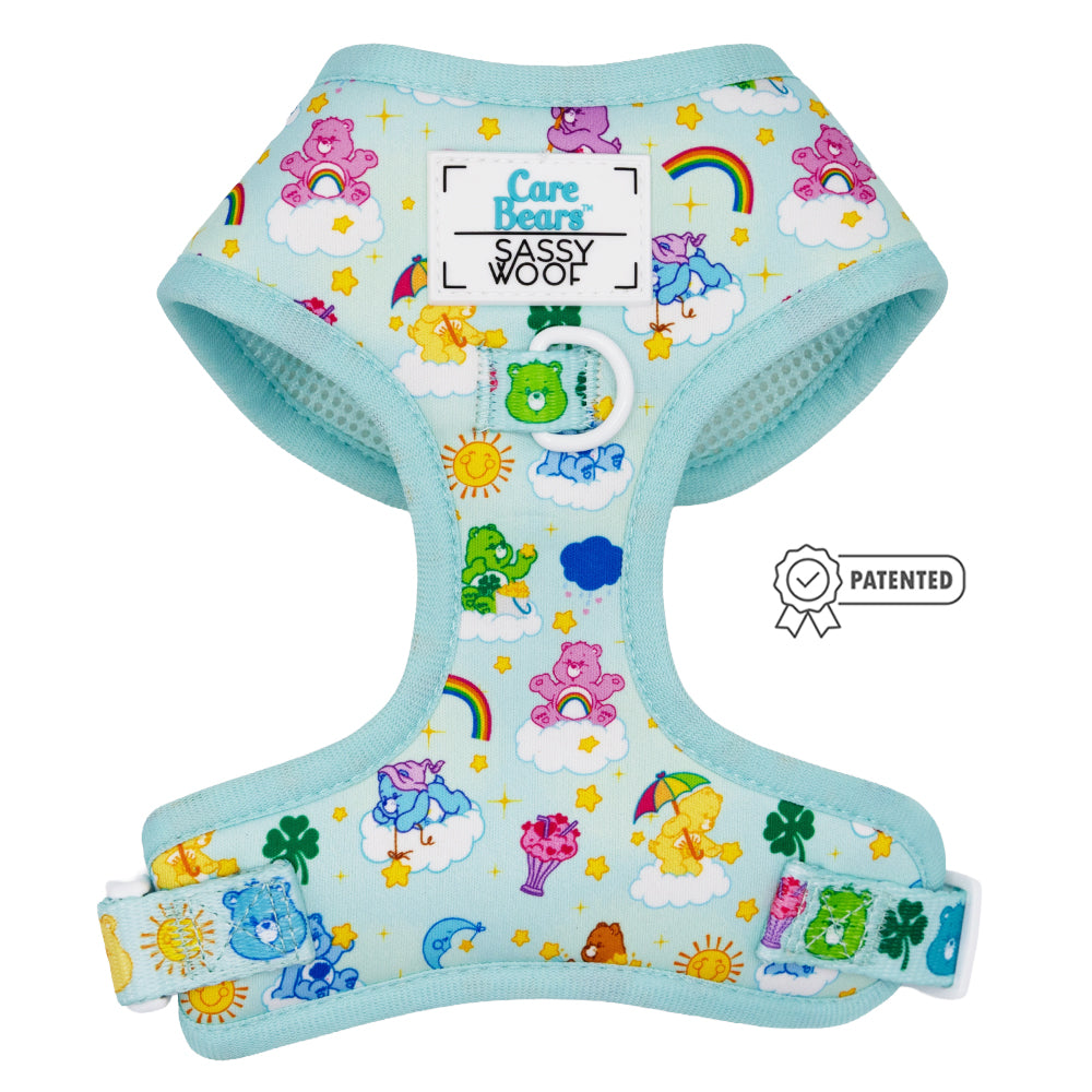 The Sassy Woof Dog Two Piece Bundle – Care Bears™ Care-a-Lot features a light blue harness with rainbows, suns, clouds, stars, and clovers, plus a matching adjustable leash. Sassy Woof logo and Patented badge are on the chest.