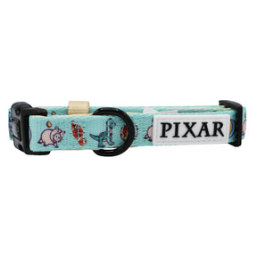 A light blue adjustable dog collar from Sassy Woof, featuring black plastic buckles, a metal ring, a white PIXAR tag, and small Toy Story character images—perfect for Disney and Pixar fans.