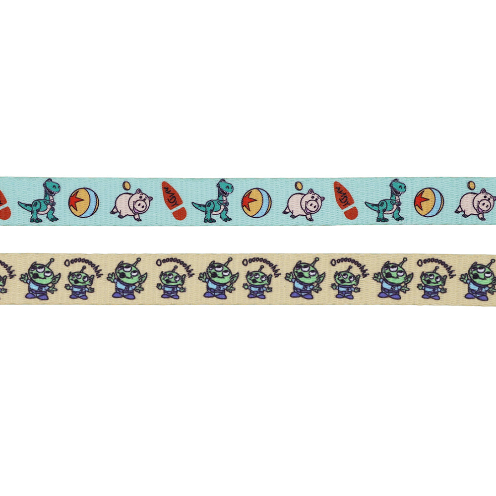 The Dog Two Piece Bundle - Disney and Pixar's Toy Story by Sassy Woof features a ribbon with Rex, a surfboard, ball, and piggy bank on top; the bottom shows three-eyed aliens and "Ooooooh!"—great for an adjustable harness or leash.
