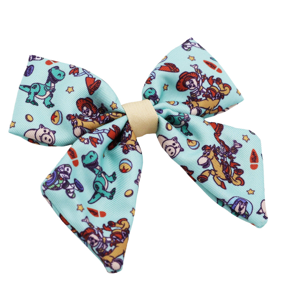 The Sassy Woof Dog Sailor Bow - Disney and Pixar's Toy Story features Woody, Buzz Lightyear, Jessie, stars, planets, and a cream center knot—perfect for your pup’s next dog park visit!.