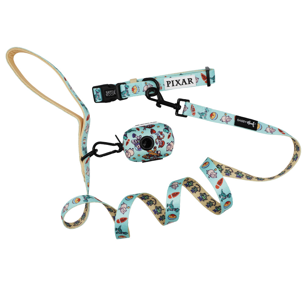 The Sassy Woof Collar Three Piece Bundle - Disney and Pixar's Toy Story includes a light blue adjustable collar, leash with comfy handle, and matching waste bag holder featuring colorful Toy Story designs.