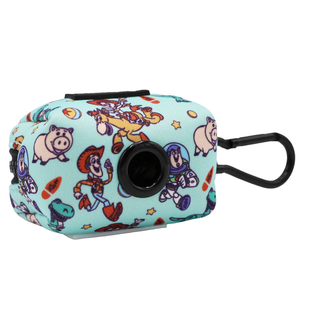 The Sassy Woof Dog Waste Bag Holder – Disney and Pixar’s Toy Story features a light blue design, black clip, and cartoon images of Woody, Buzz Lightyear, Jessie, Rex, and Hamm with star accents for extra charm.