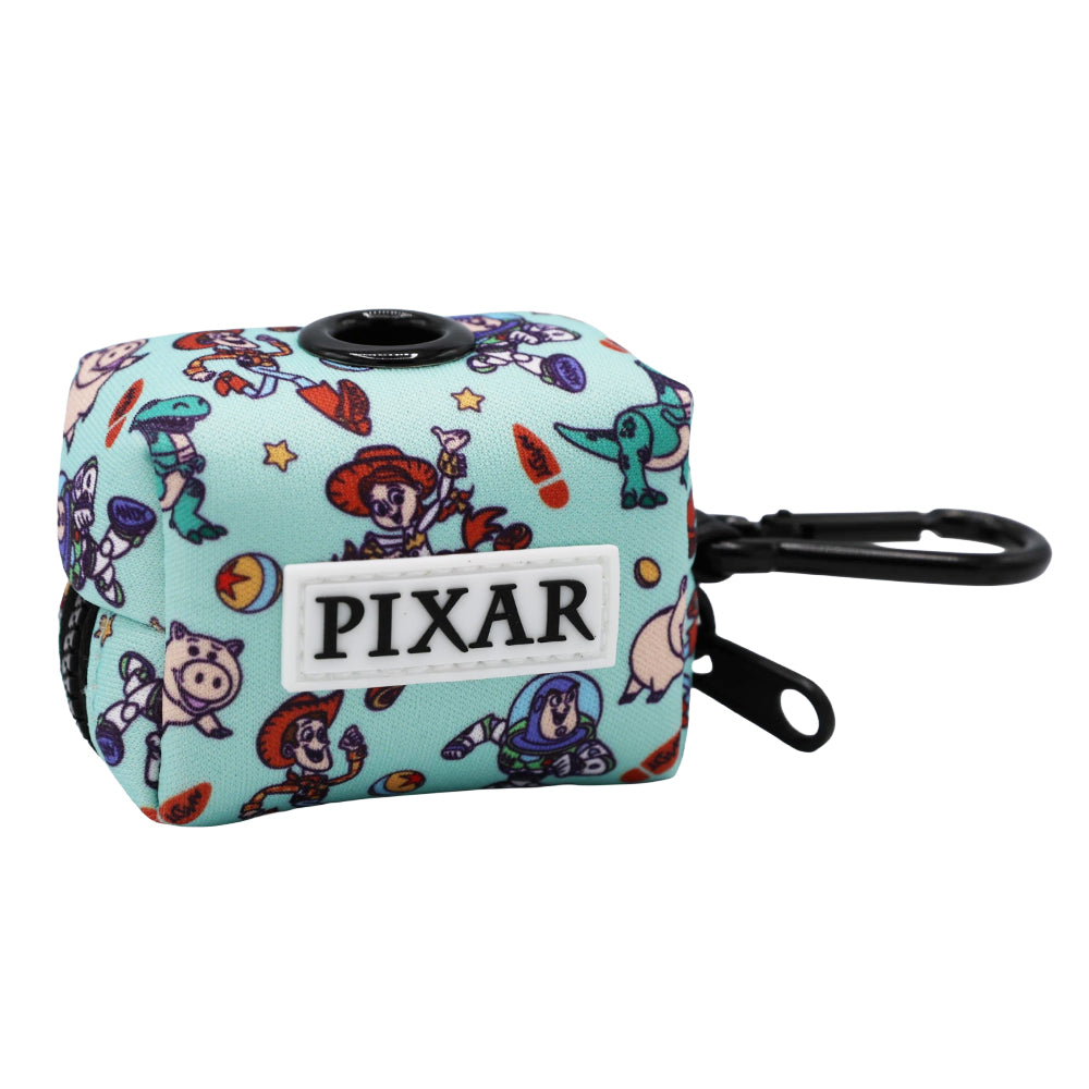 The Sassy Woof Dog Waste Bag Holder - Disney and Pixar's Toy Story features a light blue rectangular design with Pixar characters, a black dispenser opening, PIXAR label, and black clip—perfect for fun Disney dog walks.