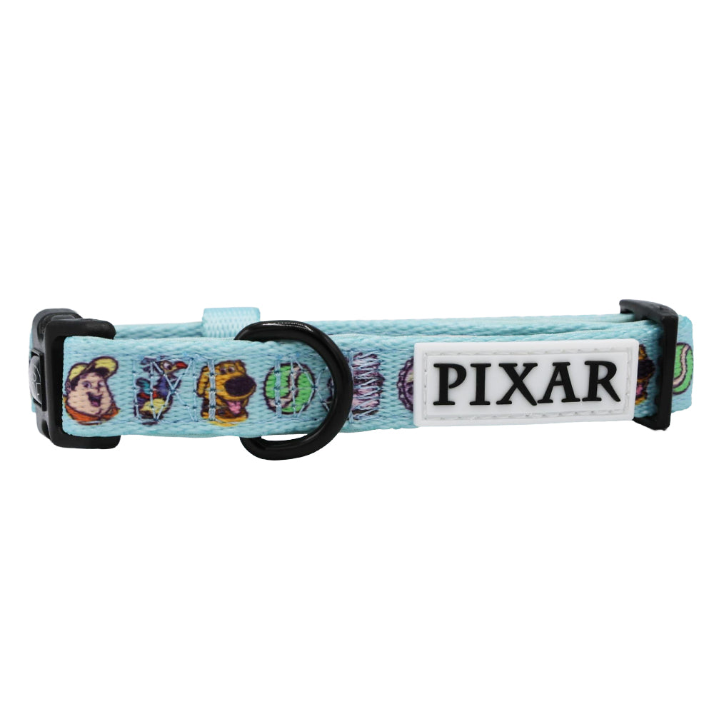 The Sassy Woof Dog Collar - Disney and Pixar's Up features a light blue design with Pixar character prints, black plastic buckle, metal ring, and a white “PIXAR” logo patch—perfect for matching with your favorite Disney dog harness.