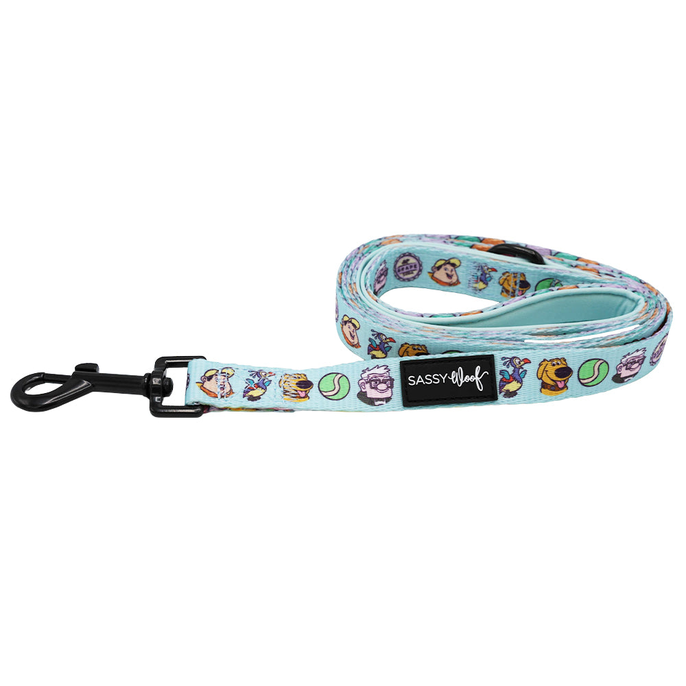 The Sassy Woof Dog Leash - Disney and Pixar's Up features a light blue design with cartoon dogs and tennis balls, a black clip, and a black Sassy Woof label.
