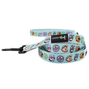 The Dog Leash - Disney and Pixar's Up by Sassy Woof features playful cartoon dog faces, tennis balls, grape soda motifs, a black metal clasp, and a Sassy Woof label—perfect for pairing with an adventure dog harness on fun outings.