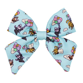 The Sassy Woof Dog Sailor Bow - Disney and Pixar's Up features light blue fabric decorated with raccoons, bees, and dogs holding pastel balloons among clouds. It’s adjustable and designed to fit your dog's collar.