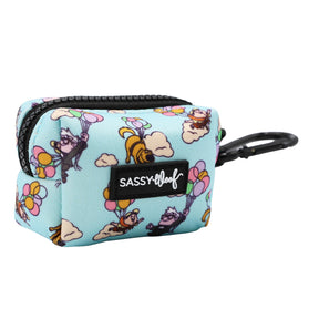 The Sassy Woof Dog Waste Bag Holder - Disney and Pixar's Up is a small, rectangular, light blue pouch with a black zipper, carabiner, dog and balloon print, and a black SASSY WOOF logo patch on the front.