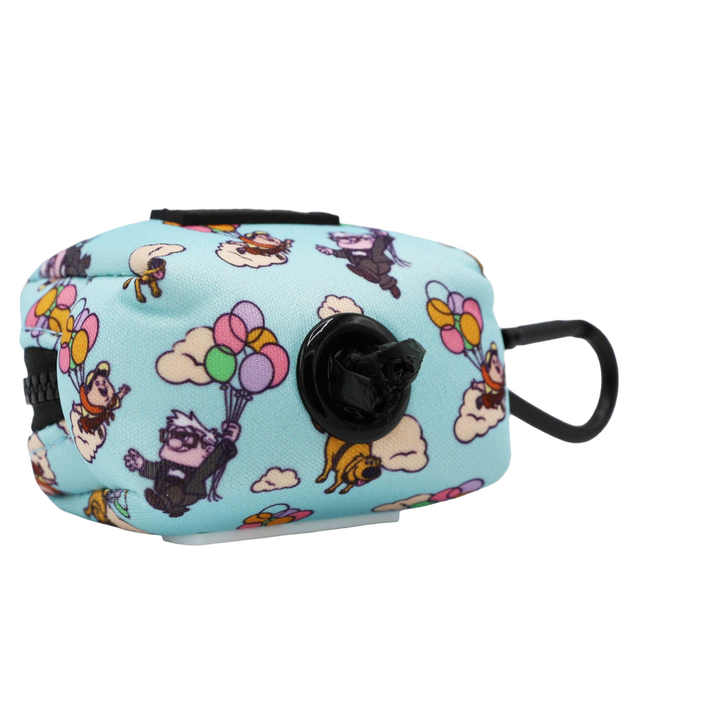 Introducing the Sassy Woof Dog Waste Bag Holder - Disney and Pixar's Up. This light blue dispenser, featuring cartoon dogs with balloons reminiscent of the playful Disney Up aesthetic, adds a whimsical touch to your walks. The sleek black holder securely stores waste bag rolls and includes a durable black carabiner for easy attachment to your leash, dog harness, or bag.