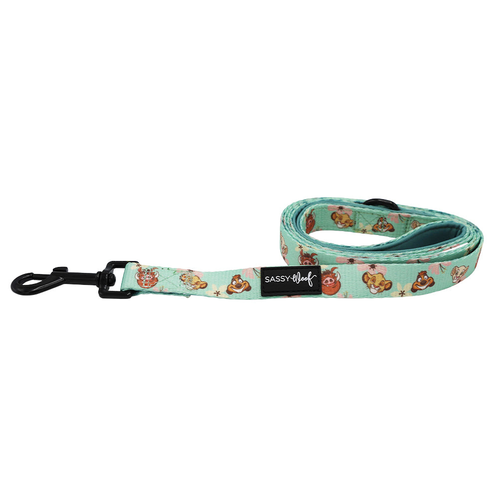A mint green Dog Leash - Disney’s The Lion King Wild Kingdom by Sassy Woof, featuring printed cartoon animal faces inspired by the playful vibe of The Lion King, with a black metal clasp and a black Sassy Woof tag.