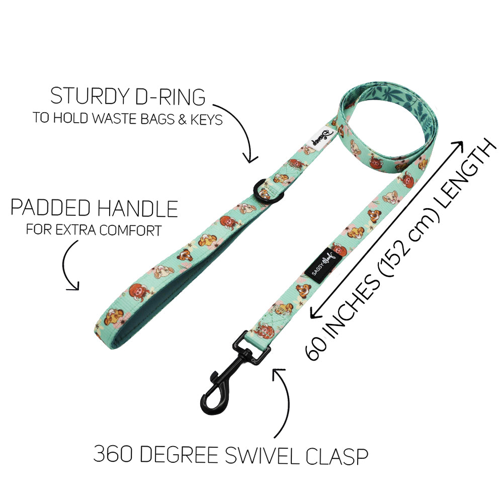 Introducing the Sassy Woof Dog Two Piece Bundle – Disney’s The Lion King Wild Kingdom! This light blue leash, adorned with playful cartoon dogs, features a padded handle for comfort, a sturdy D-ring for attaching bags or keys, and a 360-degree swivel clasp. Measuring 60 inches (152 cm) in length, it’s designed to perfectly complement your Lion King or any Disney dog harness while combining fun style with practical comfort.
