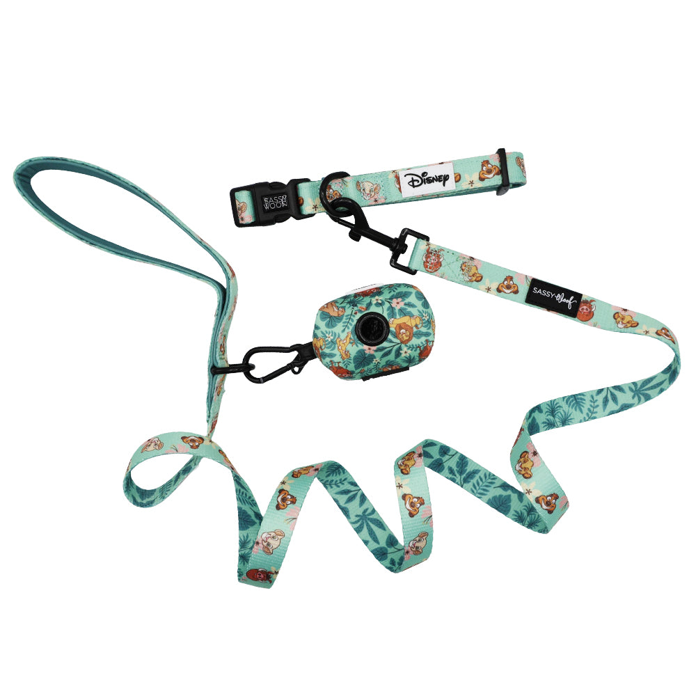 Introducing the Sassy Woof Dog Collar Three Piece Bundle – Disney’s The Lion King Wild Kingdom: a light blue Disney-themed set featuring a collar, leash, and poop bag holder, each adorned with green leaf patterns and beloved Lion King character illustrations. This unique trio is the perfect choice for fans seeking distinctive Disney dog accessories.