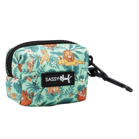 A compact, rectangular, teal Dog Waste Bag Holder from Sassy Woof’s Disney’s The Lion King Wild Kingdom collection, featuring playful animal prints inspired by the jungle, a black zipper and clip for easy attachment, and a front patch labeled Sassy Woof.