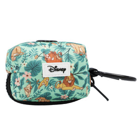 The Sassy Woof Dog Waste Bag Holder - Disney’s The Lion King Wild Kingdom is a small green pouch featuring Lion King characters and floral patterns, complete with a black clip and the Disney logo on the front. It pairs perfectly with your favorite Lion King or jungle dog harness.