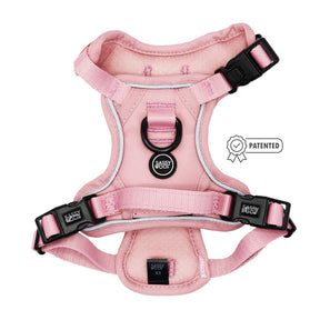 The Sassy Woof Dog Step-in Harness in Dusty Rose features black buckles, reflective straps, and a center label, shown on a white background with a small Patented badge to the right.