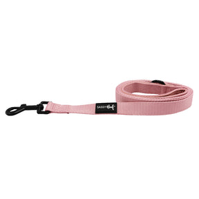 The Dog Leash - Dusty Rose by Sassy Woof features a padded neoprene handle, sturdy black metal clasp, and a black SASSY WOOF label. Pair it with the matching adjustable harness for a stylish walk.