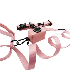 The Sassy Woof Dog Three Piece Bundle in Dusty Rose includes a pink leash set and collar with black hardware, plus a small SAFE WOOF WOOF pouch, all neatly arranged on a white background.