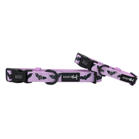 Two Sassy Woof “Lil Batty” purple adjustable dog collars, featuring black bat patterns, sturdy black buckles, and signature Sassy Woof tags—displayed against a white background. These are the perfect bat-themed collars to pair with your favorite fall dog harness.
