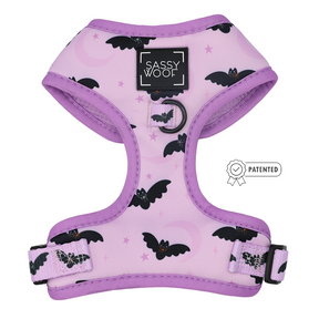 Introducing the Dog Adjustable Harness - Lil Batty by Sassy Woof: this lavender harness features a whimsical bat pattern, adjustable straps, a secure ring for leash attachment, and the classic black Sassy Woof logo. A patented icon is displayed to the right—ideal for adding some spooky charm to your dog’s walk this Fall.