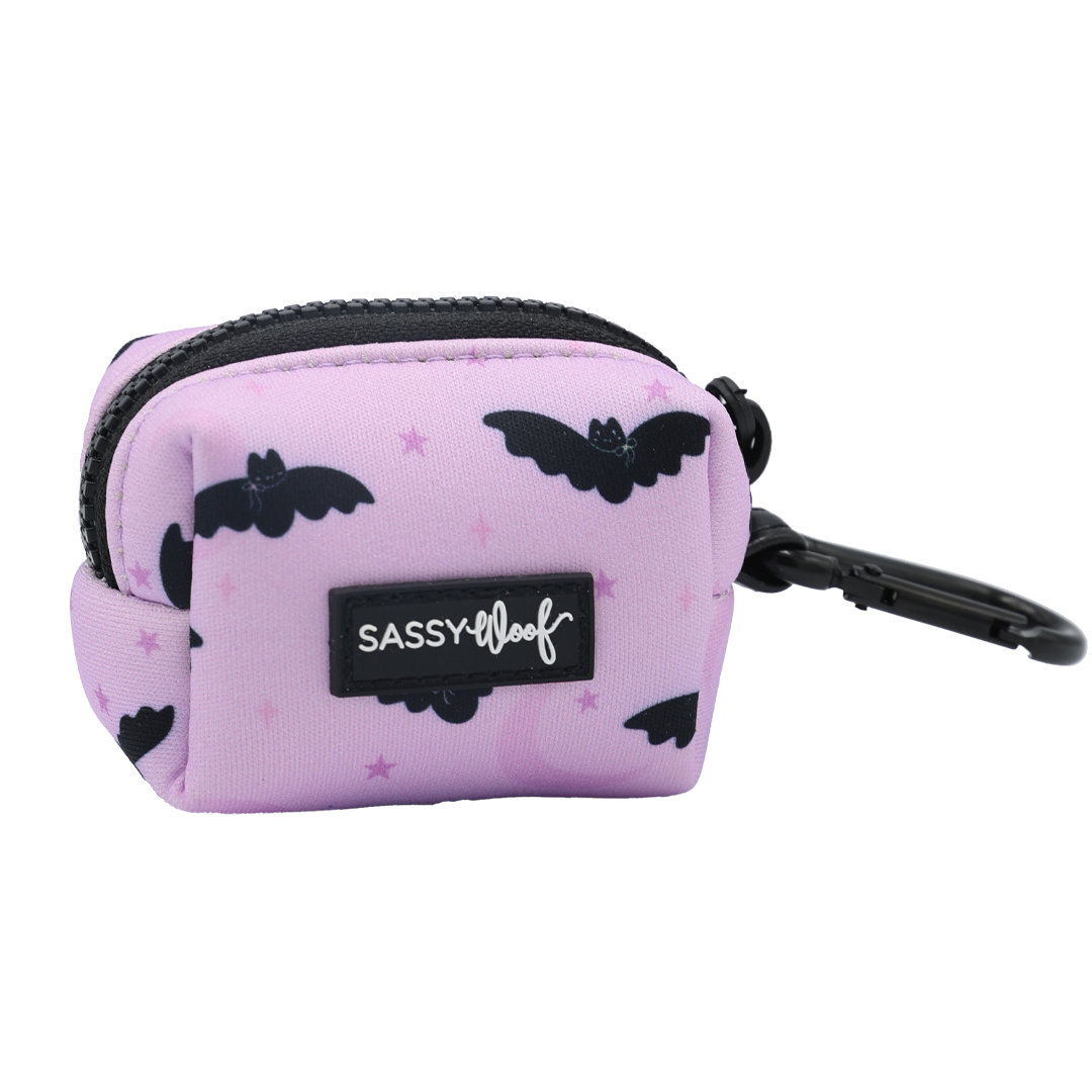 Carry treats or waste bags in style with the Sassy Woof Dog Waste Bag Holder - Lil Batty. This small, light purple pouch features playful black bat designs, a sturdy black zipper, and a convenient clip. Perfect for pairing with your favorite bat dog harness or for anyone who loves spooky dog accessories—an ideal choice for a festive fall look.