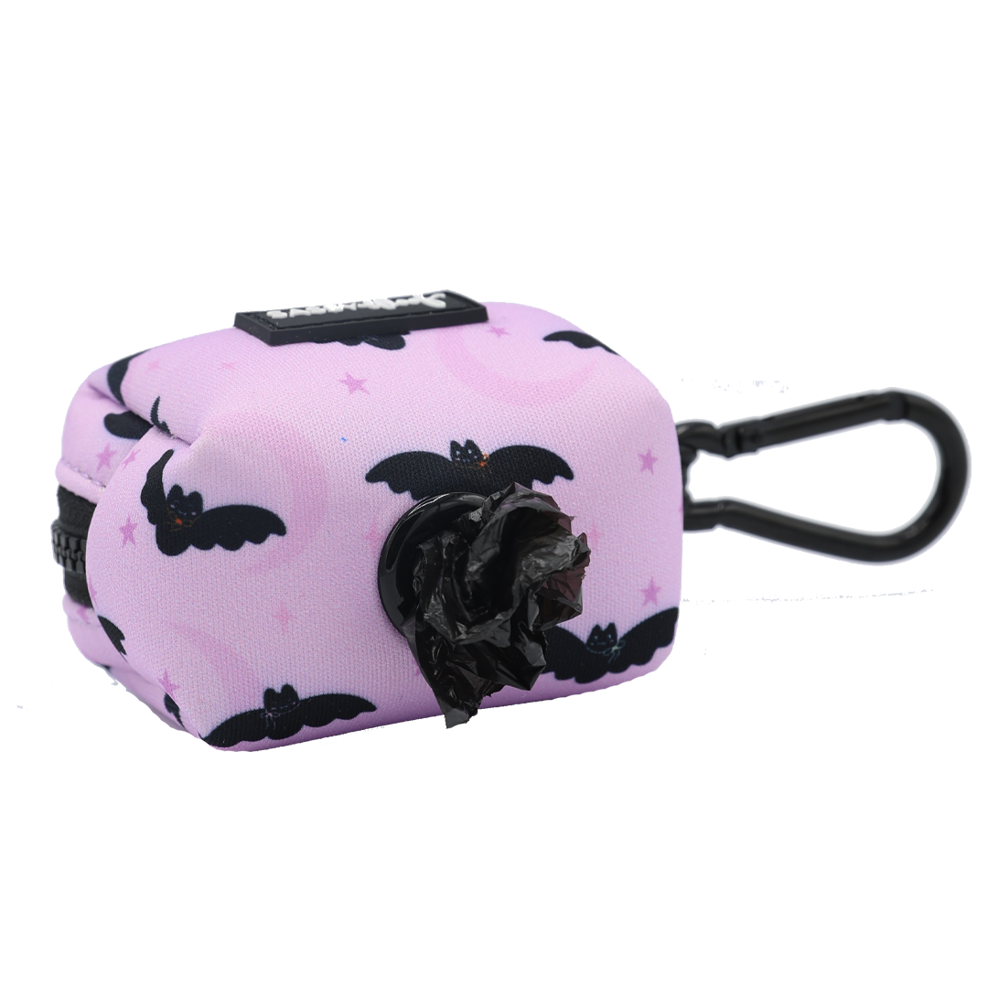 Add a fun touch of Halloween style to your daily walks with the Sassy Woof Dog Waste Bag Holder - Lil Batty. This pink pet waste bag holder features bold black bat designs and is perfect for pairing with your favorite fall dog harness or spooky dog accessories. Equipped with a convenient clip for easy attachment and an accessible opening for pulling out waste bags, it’s both practical and stylish!.