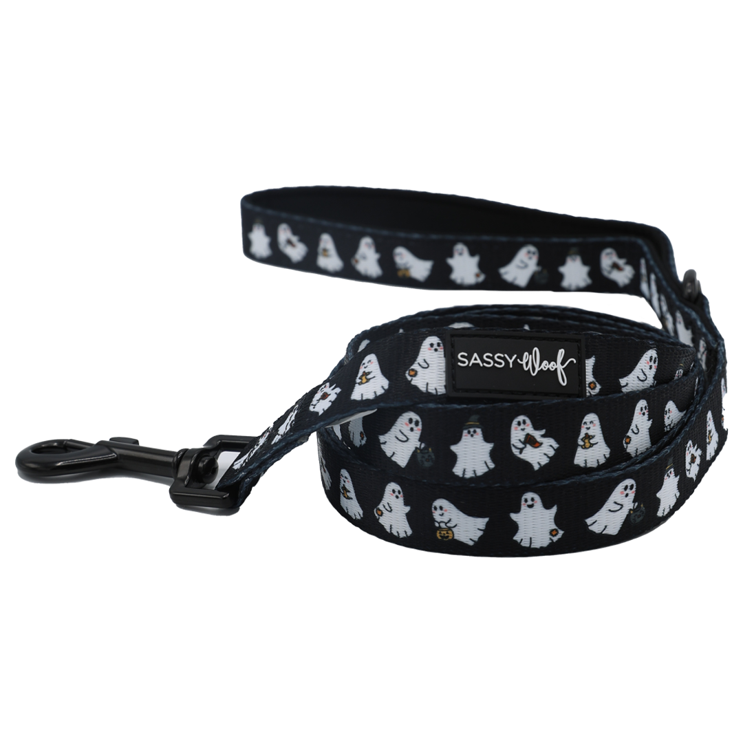 The Sassy Woof Dog Leash - Lil Boo Thing features a navy blue design with a playful white ghost pattern, a sturdy black metal clasp, and an attached Sassy Woof logo tag. This leash is part of the whimsical Lil Boo Thing Dog Collection.