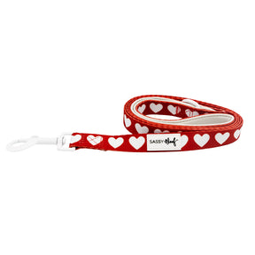 Red dog leash with white heart pattern on a white background
