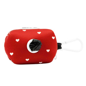 Red pouch with white heart patterns and a black plastic bag on a white background