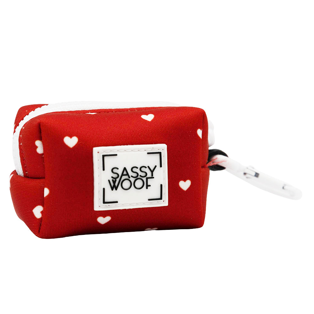 Red pouch with white heart patterns and 'Sassy Woof' logo on a white background