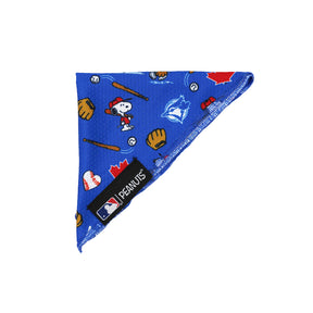 The Sassy Woof Dog Bandana - MLB™ x Peanuts™ Toronto Blue Jays™ features Snoopy playing baseball among bats, gloves, balls, and red maple leaves, plus a bluebird logo and an official black MLB Peanuts Toronto Blue Jays label on the edge.