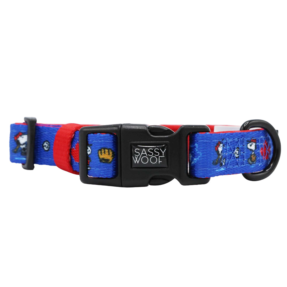 The Sassy Woof Harness Three Piece Bundle features a blue and red adjustable dog collar with MLB™ x Peanuts™ Toronto Blue Jays™ cartoon designs, a black plastic Sassy Woof buckle, and a sturdy black metal D-ring.