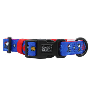 The Sassy Woof Harness Three Piece Bundle features a blue and red adjustable dog collar with MLB™ x Peanuts™ Toronto Blue Jays™ cartoon designs, a black plastic Sassy Woof buckle, and a sturdy black metal D-ring.
