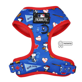 The Sassy Woof Harness Three Piece Bundle - MLB™ x Peanuts™ Toronto Blue Jays™ features a blue dog harness with red trim, Peanuts characters, baseball gear, maple leaves, team logos, an MLB Peanuts label, and a Patented badge.