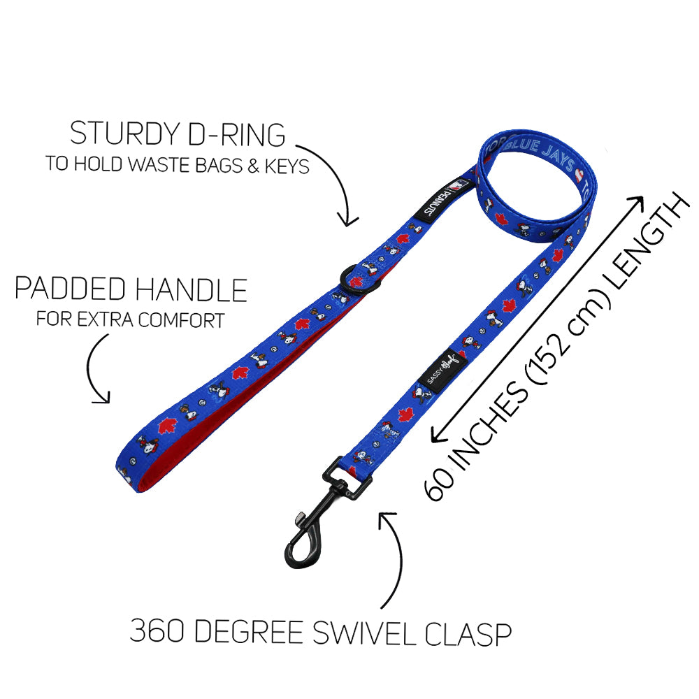 The Harness Three Piece Bundle - MLB™ x Peanuts™ Toronto Blue Jays™ by Sassy Woof features a padded handle, sturdy D-ring for keys or bags, 60-inch length, and swivel clasp—perfect with your adjustable harness. Text and arrows highlight every feature.