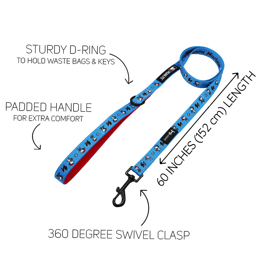 The Sassy Woof Dog Two Piece Bundle - MLB™ x Peanuts™ Miami Marlins™ includes a blue leash with paw prints, sturdy D-ring, padded handle, and swivel clasp. Measures 60 inches (152 cm); perfect for baseball-loving pet owners or pairing with a Snoopy harness.