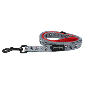 The Sassy Woof Dog Leash - MLB™ x Peanuts™ Chicago White Sox™ is gray with a black clasp, red inner lining, and features a playful cartoon dog pattern. A Sassy Woof label is sewn near the clasp.