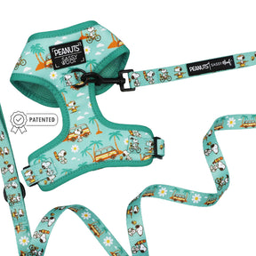 The Sassy Woof Dog Two Piece Bundle - Peanuts™ Road Trippin' features a turquoise adjustable dog harness and leash set with Peanuts characters, palm trees, surfboards, cars, Sassy Woof labels, and a patented icon on the left side.