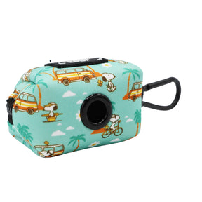 The Collar Three Piece Bundle - Peanuts™ Road Trippin' by Sassy Woof is a small teal bag featuring Snoopy surfing, biking, and relaxing by palm trees and yellow vans. It’s perfect for dog travel accessories with a black clip and circular opening on one side.
