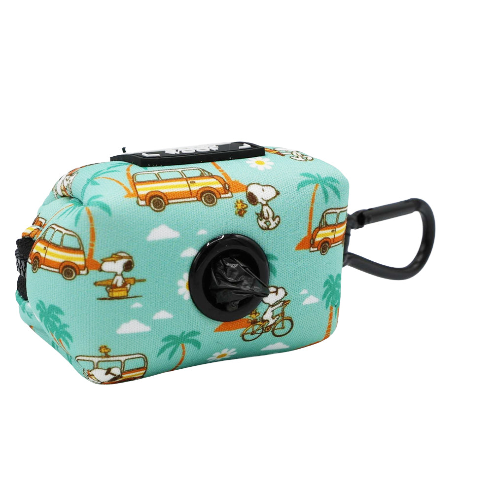 The Sassy Woof Dog Waste Bag Holder - Peanuts™ Road Trippin' is a teal, rectangular neoprene holder with Snoopy, yellow vans, and palm trees, plus a black clip and roll of bags—great for dog adventures or matching your harness.