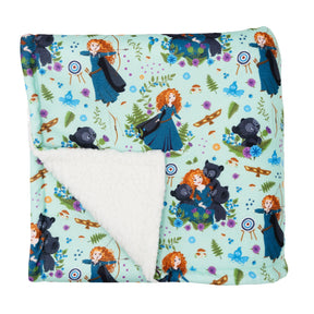 The Sassy Woof Pet Blanket - Disney's Merida is a soft sherpa dog blanket, featuring Merida in a blue dress, bears, archery targets, and forest designs. One corner folds to show the plush white lining—ideal for cozy comfort.