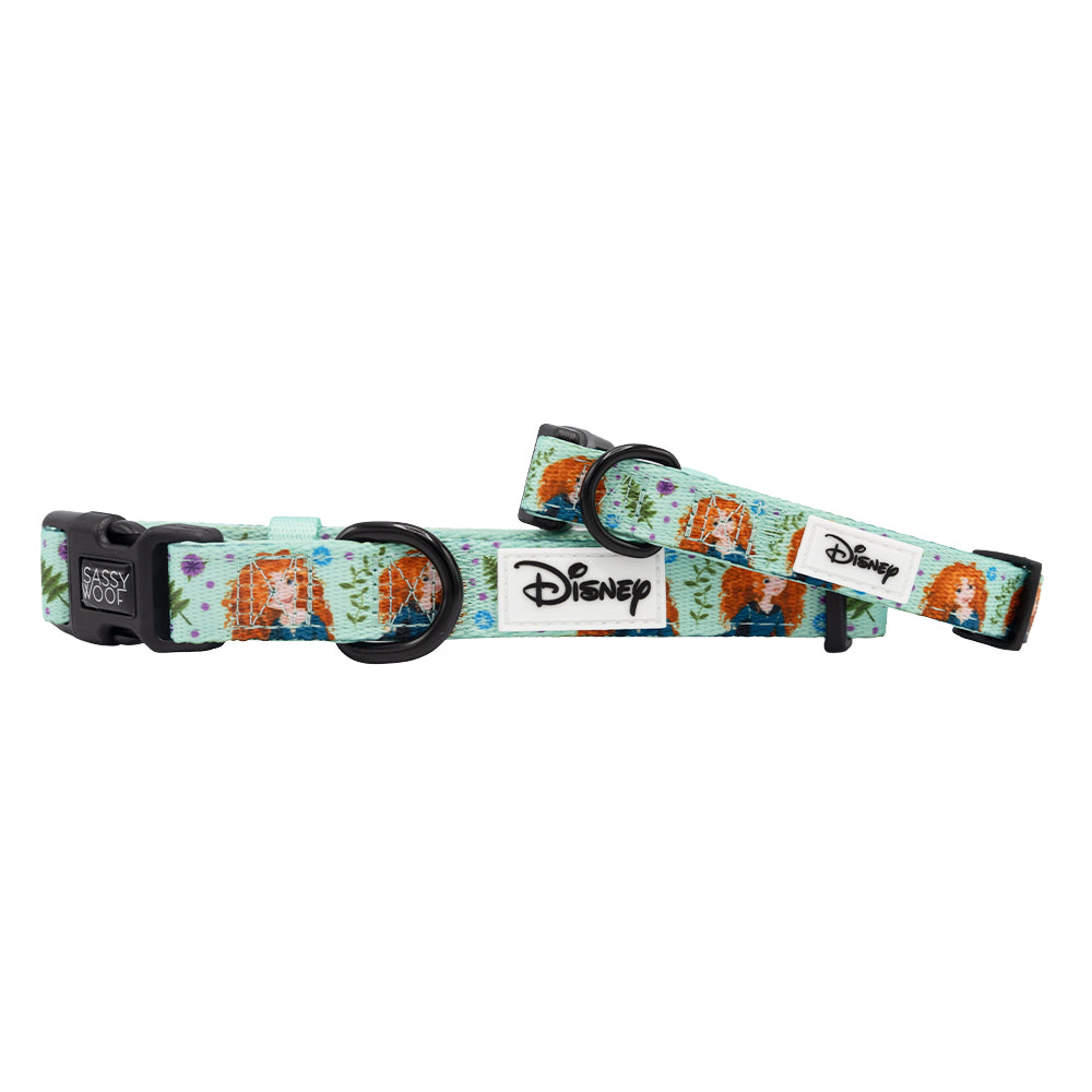 Two adjustable Dog Collar - Disney's Merida by Sassy Woof, light blue with colorful Merida designs, comfy neoprene lining, black plastic buckles, metal D-rings, and a white patch featuring the Disney logo.